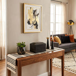 Natural black marble cremation urn in a modern shape in a home decor setting.