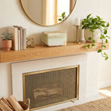 Natural marble cremation box urn in cream with golden veining in home decor setting above a fireplace.