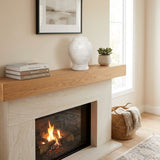Natural white marble urn featuring two hand-carved rings in a home decor setting above a fireplace.