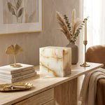 Cream & green natural marble urn with unique brown veining in a home decor setting.