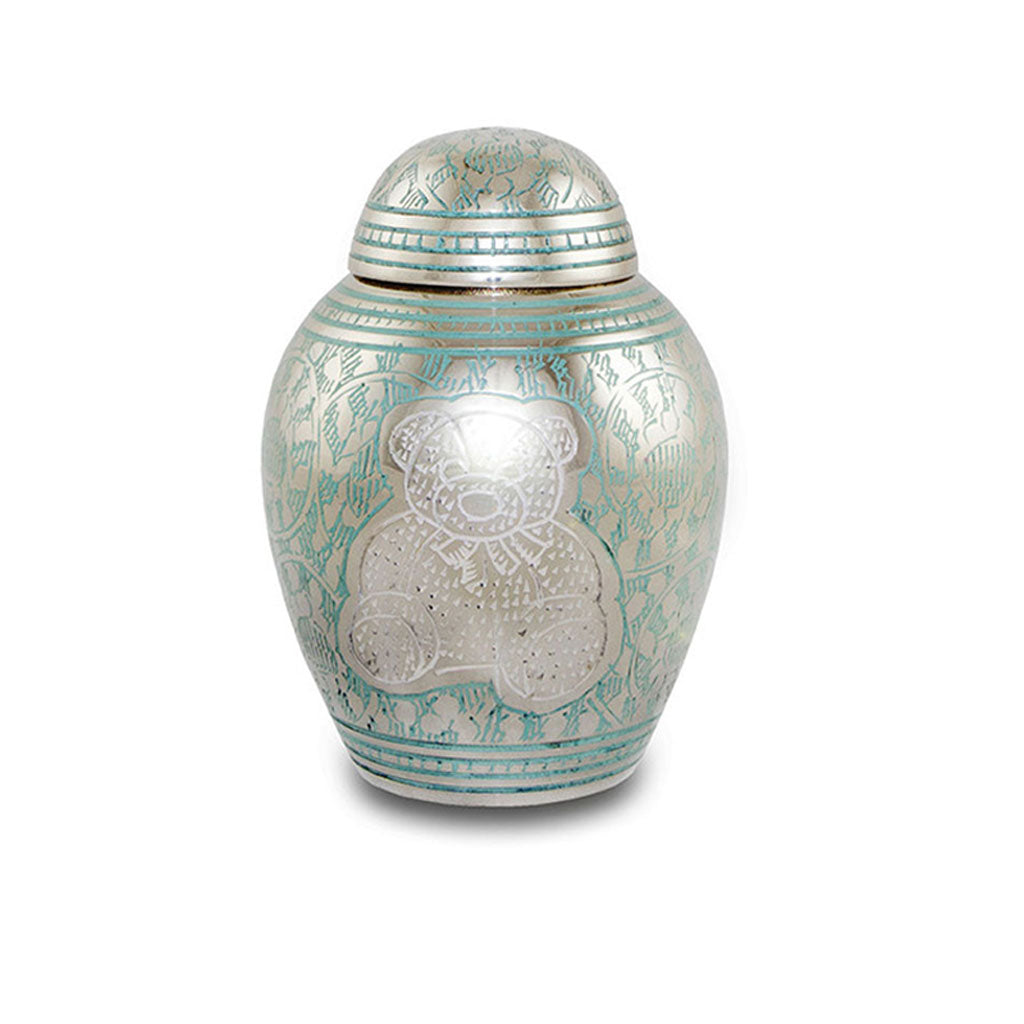 Urn for infants with intricately etched teddy bear and decorative pattern filled with light blue and white paint.