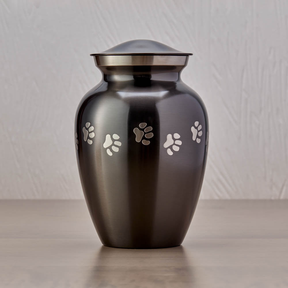 Slate grey pet urn with etched pewter paw prints wrapping around the urn main image.