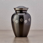 Slate grey pet urn with etched pewter paw prints wrapping around the urn main image.