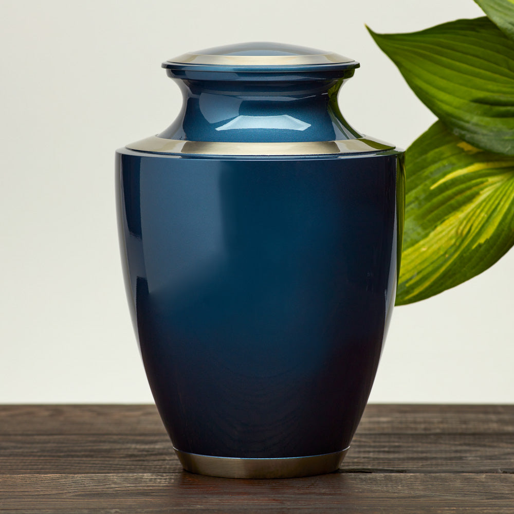 Modern metal urn in a dark blue, shimmery finish with pewter accents lifestyle 2.