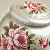 Close-up of floral rose and leaves painted onto a white cremation urn in the style of a vase with lid