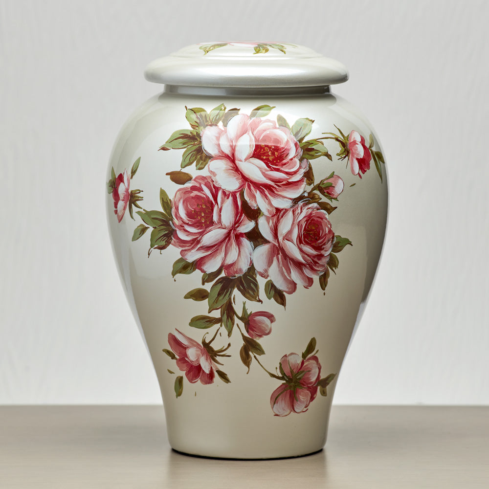 Large vase shaped cremation urn for ashes with a beautiful hand painted pattern of red and pink roses with delicate green leaves.
