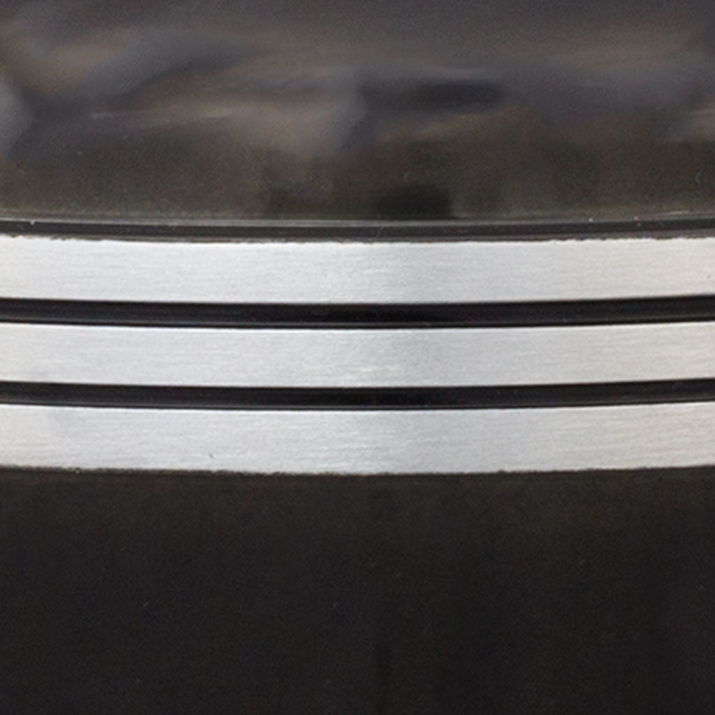 Detail of black painted urn and three pewter toned bands.
