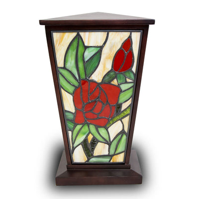 Red rose stained glass urn for cremation ashes with intricately cut glass pieces and a deep brown resin body.