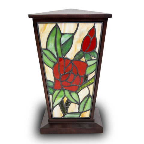 Red rose stained glass urn for cremation ashes with intricately cut glass pieces and a deep brown resin body.