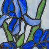 Close view of the bright blue lily flower stained glass with intricate cuts and lead free soldering.