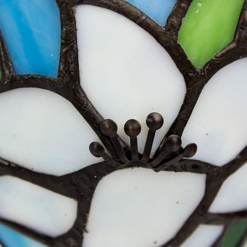 Memory lLamp with white lilies depicted in stained glass with bronze base, used for commemorating a loved one.