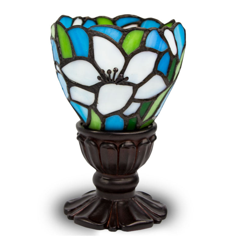 Memory lLamp with white lilies depicted in stained glass with bronze base, used for commemorating a loved one.