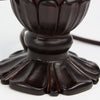 Bronze base of the white lily lamp with intricate floral features.