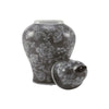 Ceramic urn with 200 cubic inch capacity with lid leaning against side of item.