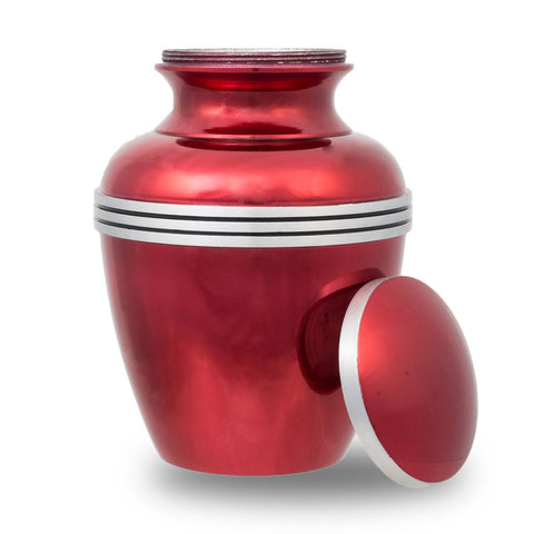Medium size cremation urn for ashes with metallic red finish and pewter trim.